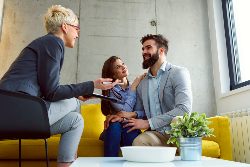 a couple speaking to a financial advisor