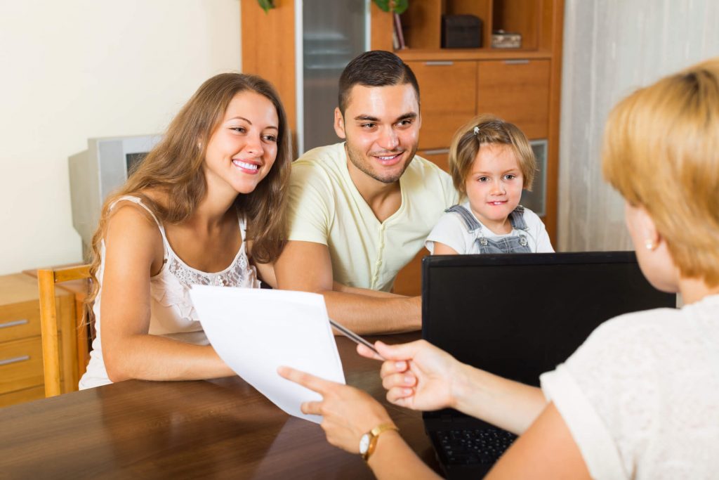 A family is talking to a life insurance agent